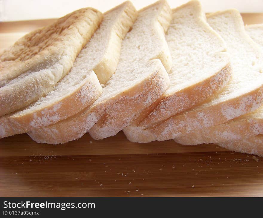 Sliced white bread on plank