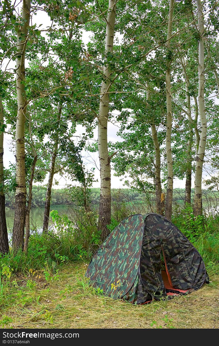 Preparation for accommodations and recreation. In the shade of trees near the river tent set, double. Preparation for accommodations and recreation. In the shade of trees near the river tent set, double.