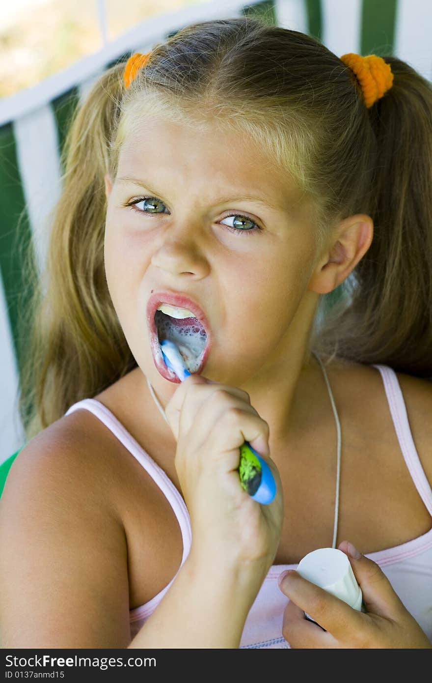 Little blond girl cleaning teeth by toothbrush. Little blond girl cleaning teeth by toothbrush