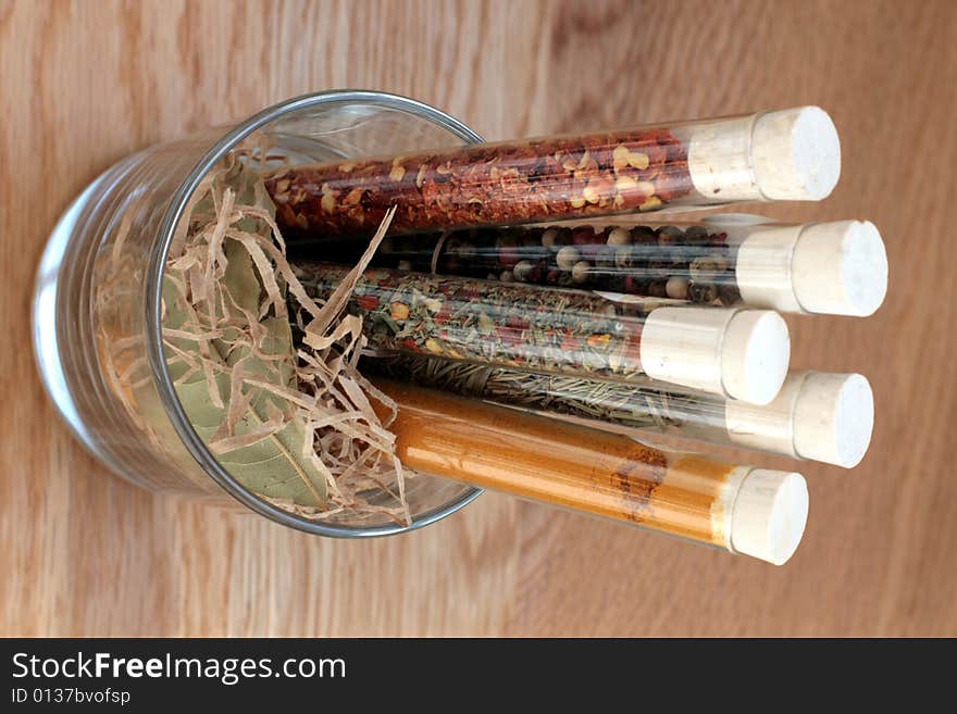 Spices in a glass on wood table