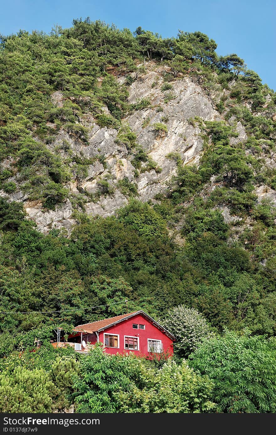 Red Mountain House near the mountain and trees.Bartin, Turkey