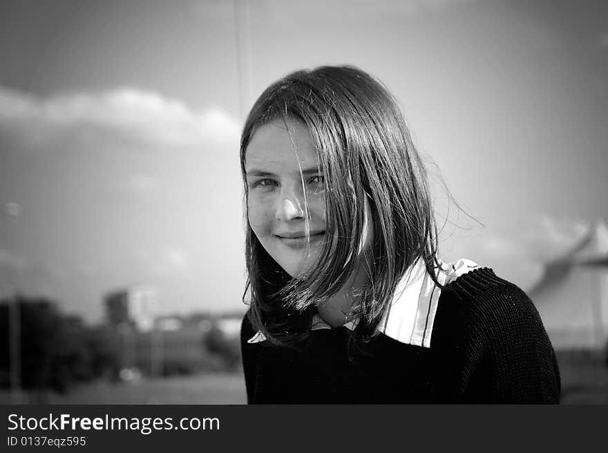 A black and white portrait of a smiling girl with a fringe. A black and white portrait of a smiling girl with a fringe