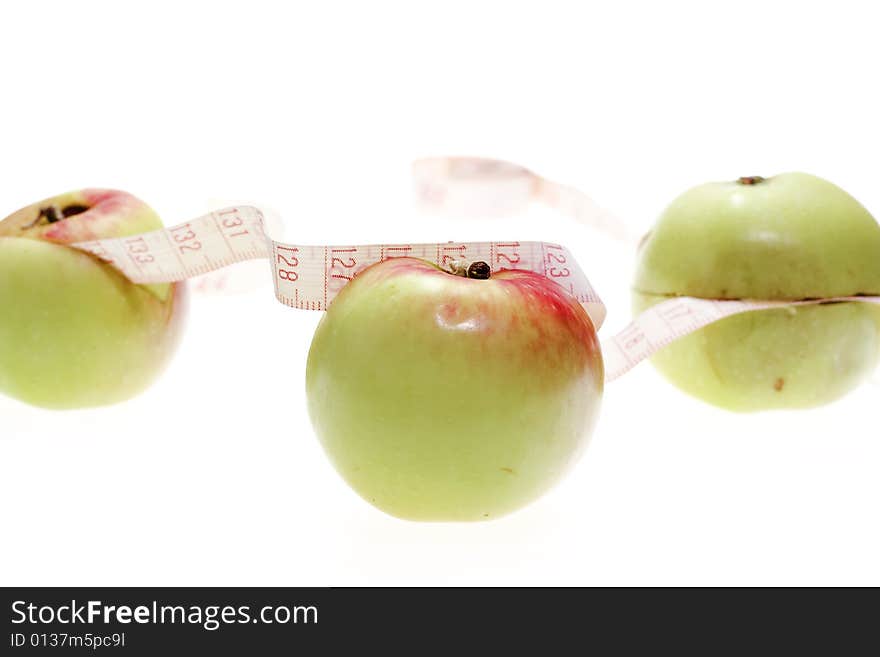 Apples and measuring tape isolated on white background.