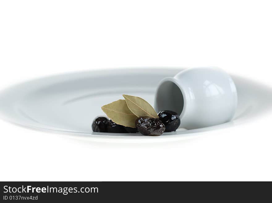 Black olives on white service plate, beauty of black