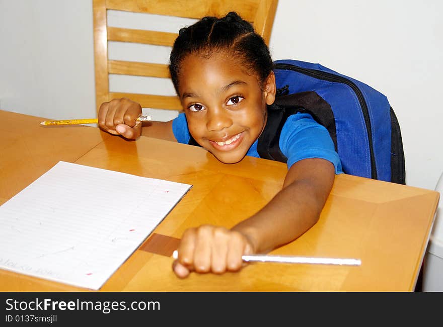 A picture of a school child happy about homework. A picture of a school child happy about homework