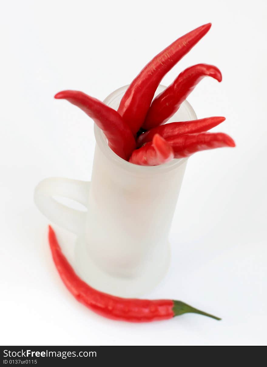 Red peppers in a frosted glass isolated. Red peppers in a frosted glass isolated