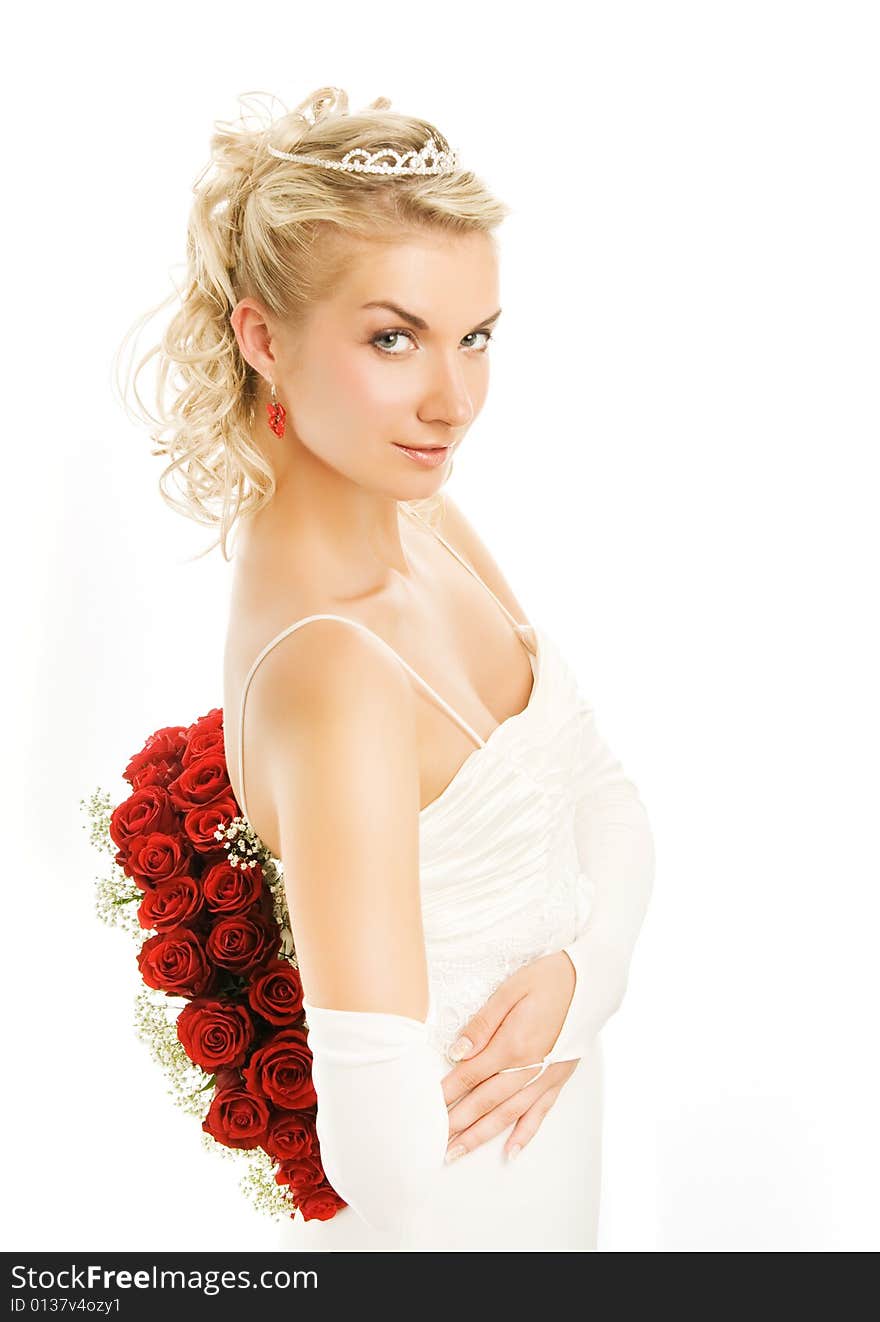 Beautiful young bride with luxury bouquet of red roses. Isolated on white background