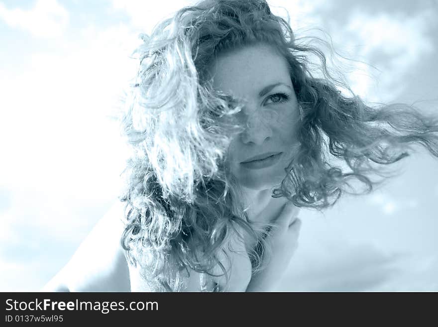 Beautiful girl with long curled hair sepia image