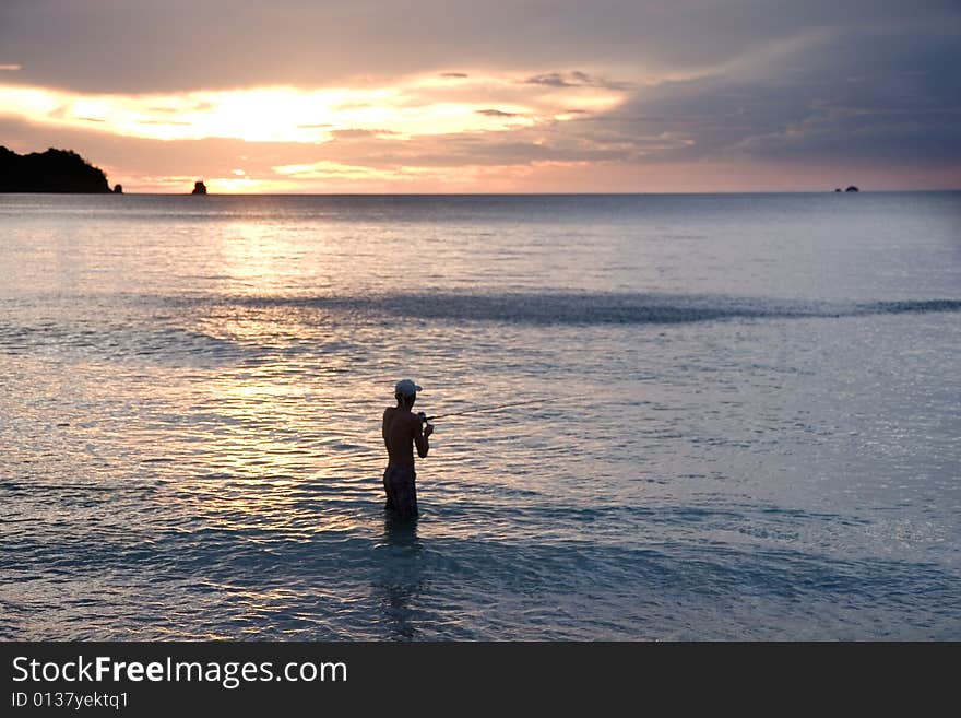 Reeling in the Surf at Sunset