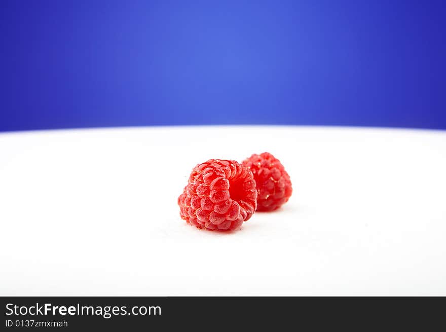 The fresh raspberry lays on a white background. The fresh raspberry lays on a white background