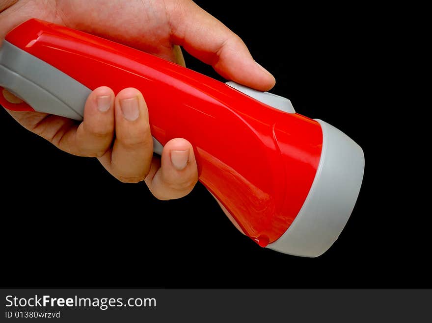 A hand holding a flash light