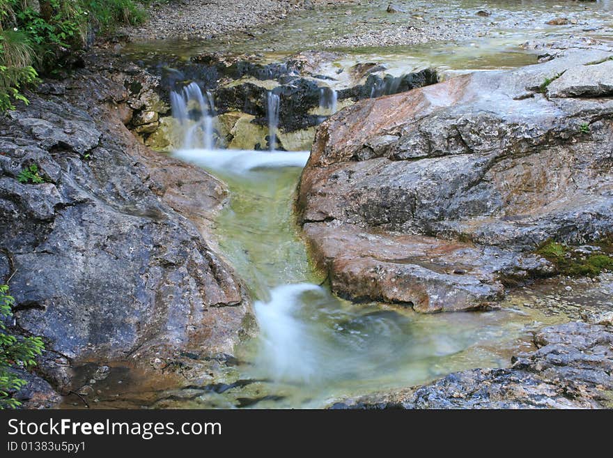 Mountain stream with small waterfall