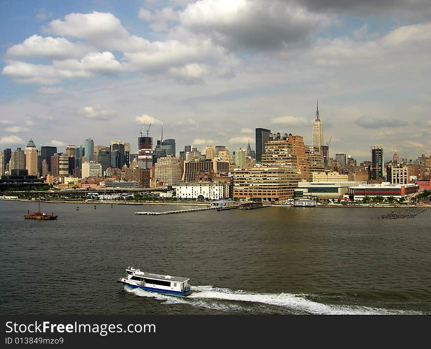 The view of ferry boat and Manhattan skyline in a background (New York City). The view of ferry boat and Manhattan skyline in a background (New York City).