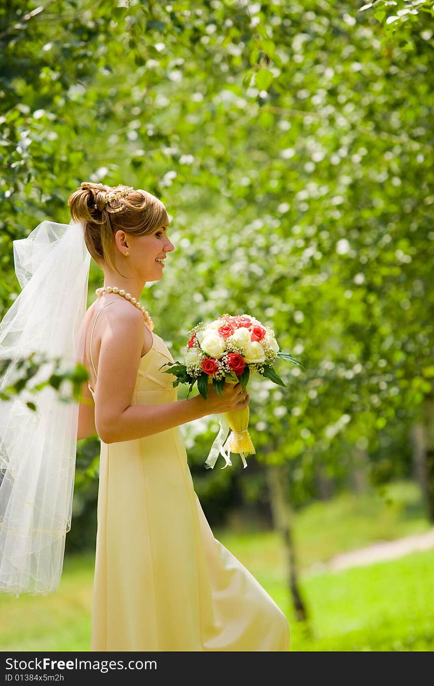 Young beautiful bride with flowers outdoor