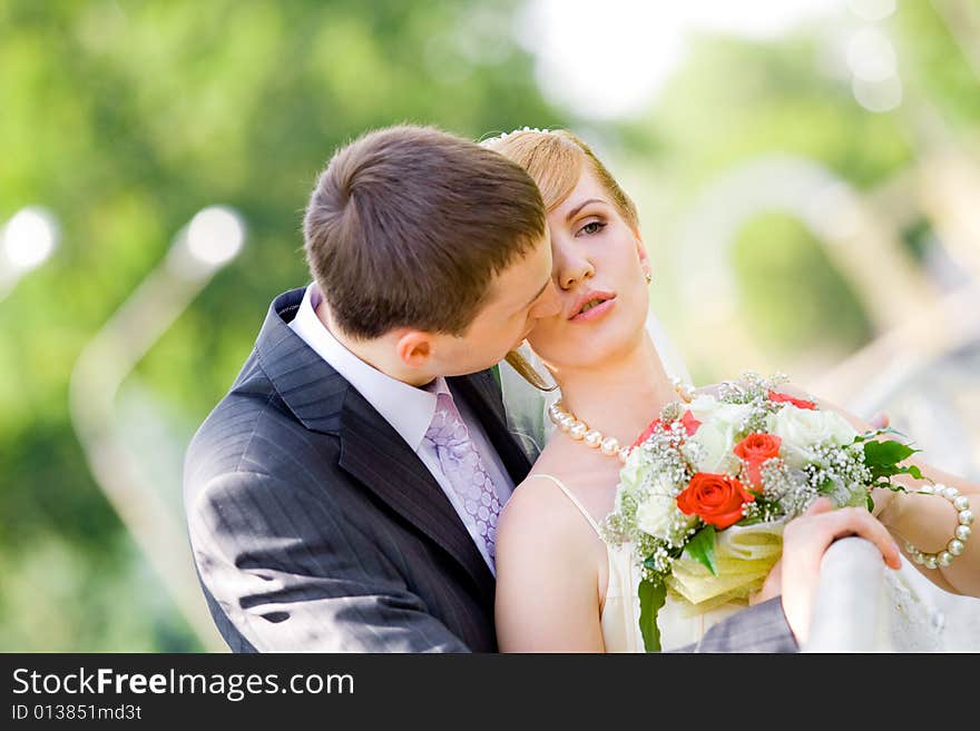 Colorful wedding shot of bride and groom kissing. Colorful wedding shot of bride and groom kissing