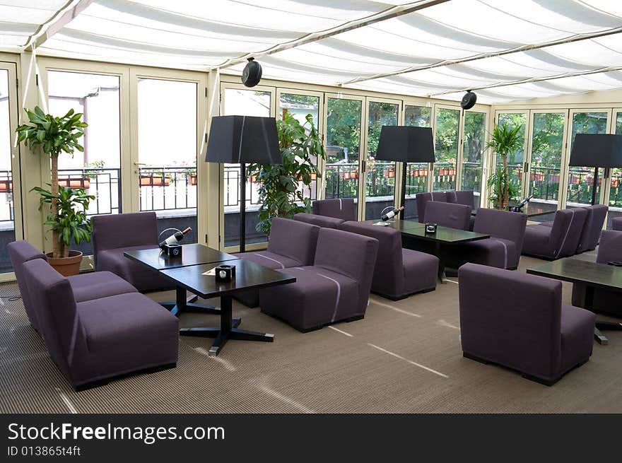 Brightly lit restaurant interior with gray chairs