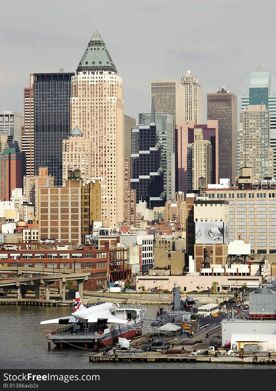 The view of the plane on a boat and Manhattan skyscrapers in a background (New York City).