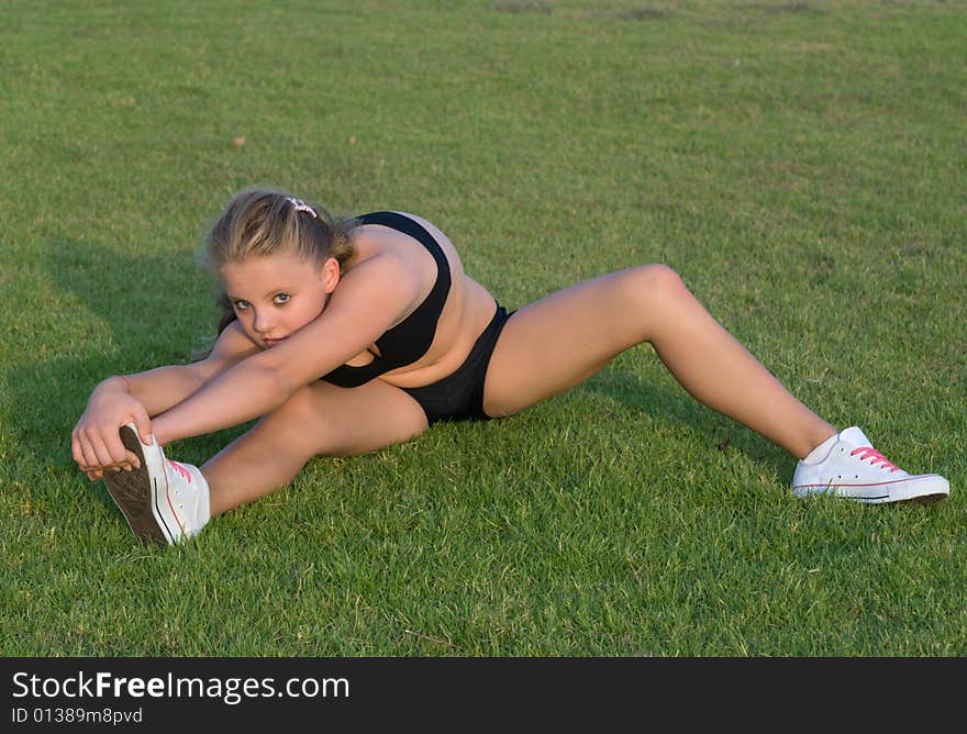 Young girl stretching her leg