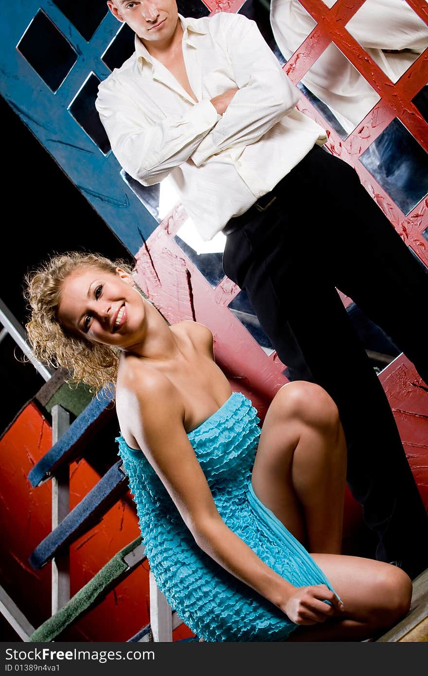 Young couple in colorful nightclub interior. Young couple in colorful nightclub interior