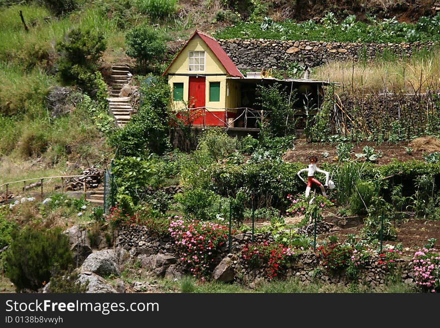 This little yellow-red coloured house with its romantic garden is to find on a hill on the portuguese isle of Madeira. This little yellow-red coloured house with its romantic garden is to find on a hill on the portuguese isle of Madeira.