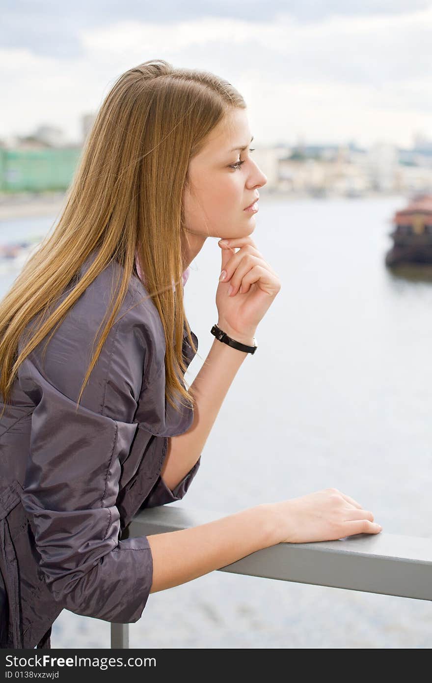 Portrait of girl city and river on background. Portrait of girl city and river on background