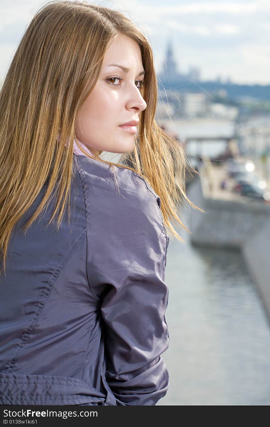 Portrait of girl city and river on background. Portrait of girl city and river on background