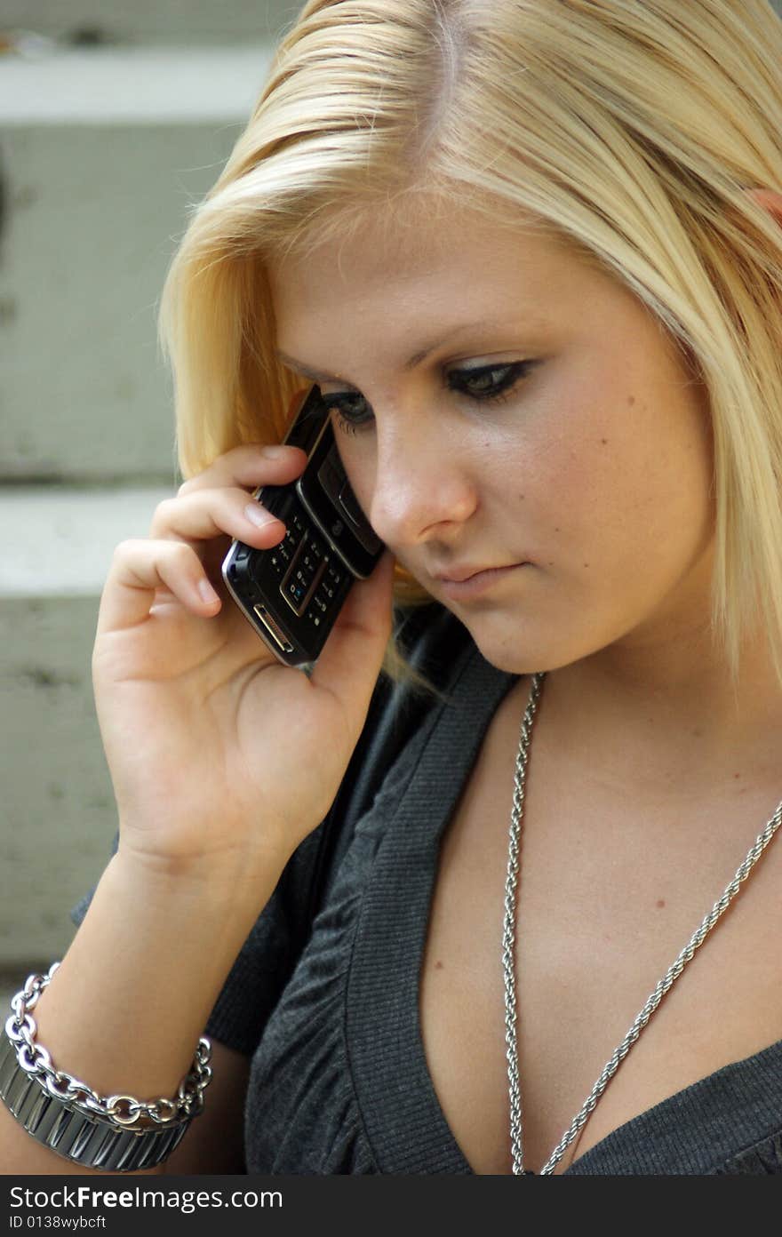 Young, Blonde Girl With A Mobile Phone.