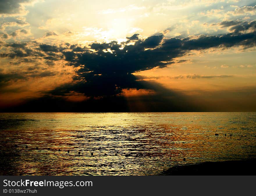 Sundown sun on background sky with cloud on sea beach