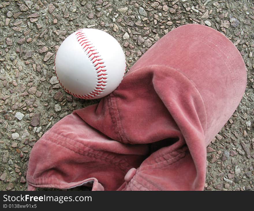 Red baseball cap and ball. Red baseball cap and ball