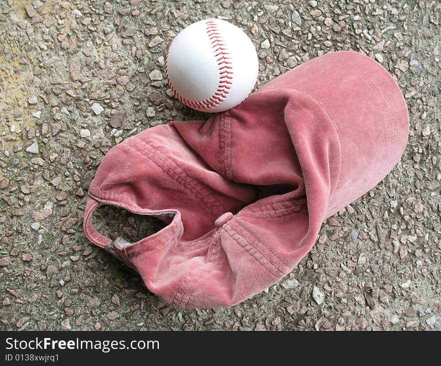 Red baseball cap and ball