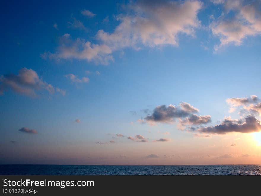 Sundown sun on background sky with cloud on sea beach