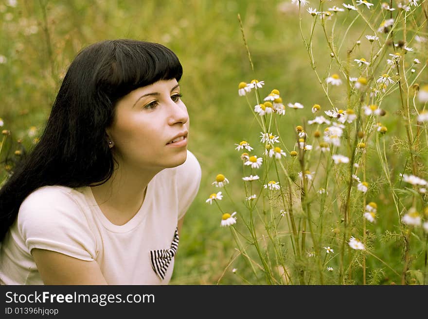 Pretty young girl relaxing on a meadow