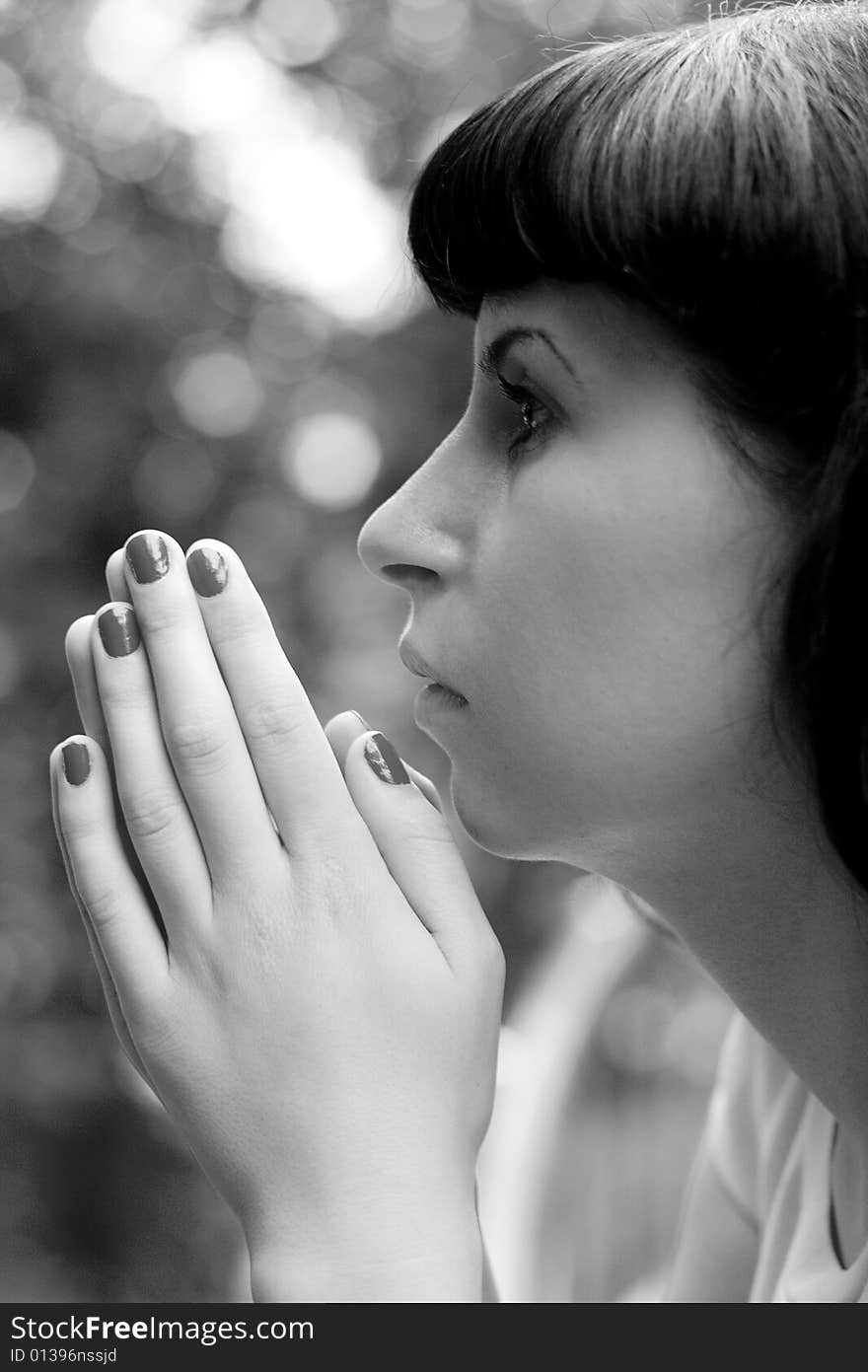 Black & white portrait of praying girl