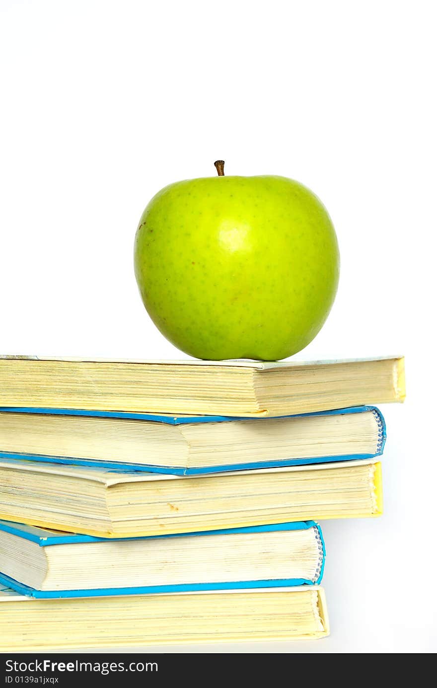 Green apple and stack of books for school