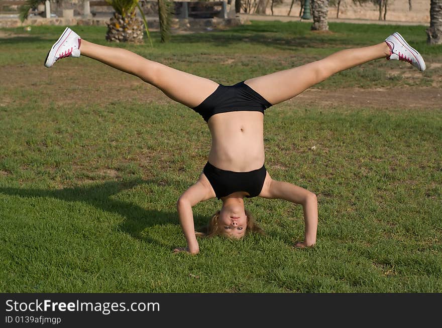 Young girl exercising in the park