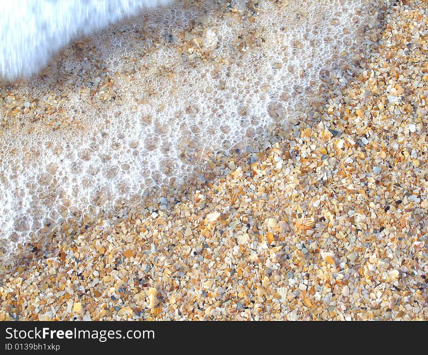 Beautiful coastline. Coast contains sand and cockleshells.