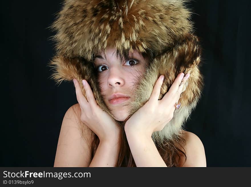 Portrait of the girl in a fur cap. Portrait of the girl in a fur cap.