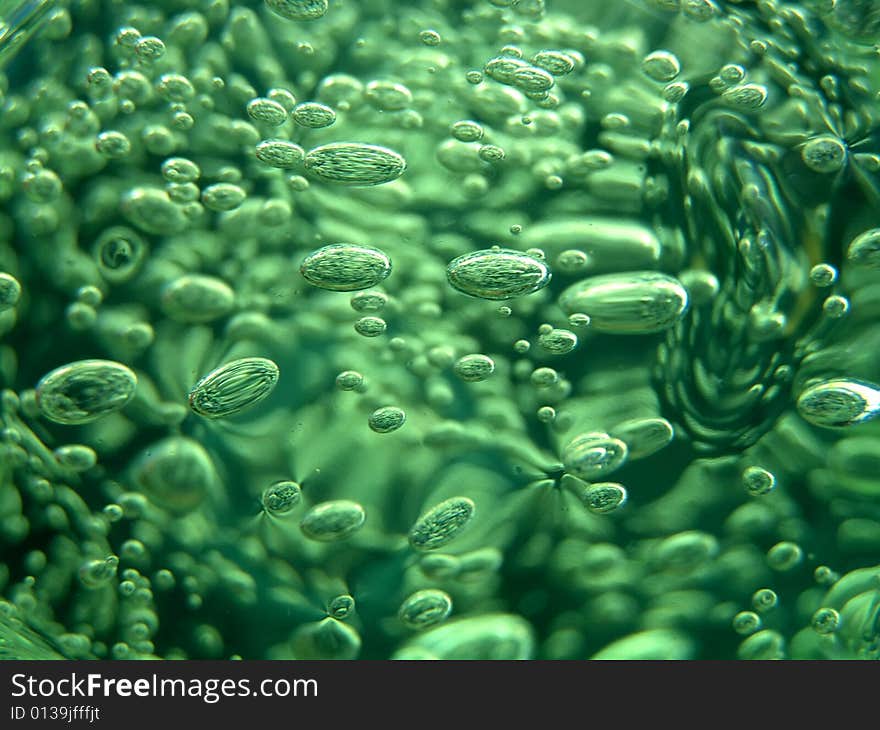 Set of green bubbles on a dark background