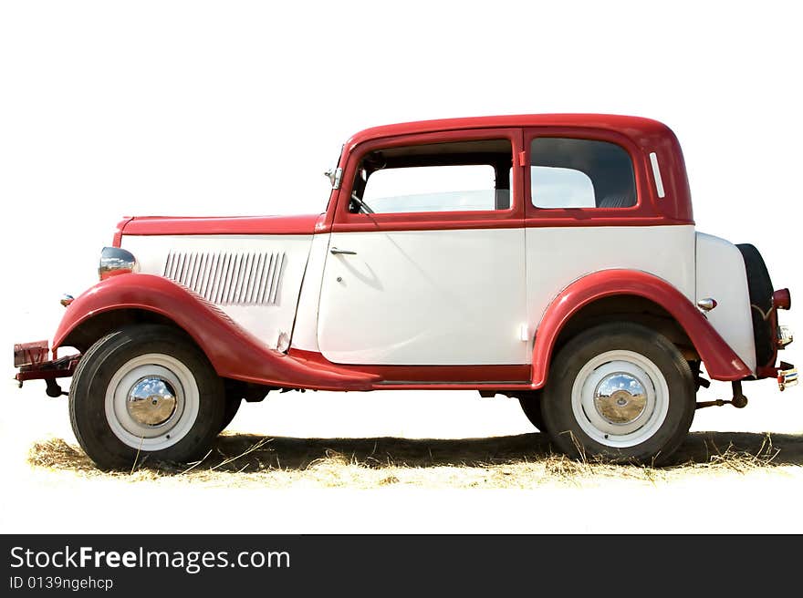 The old vintage car of white and red color. The old vintage car of white and red color