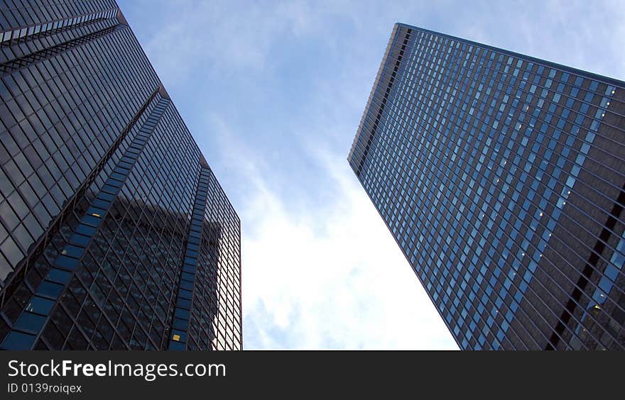 A background of tall skyscrapers on a blue sky, in Montreal.