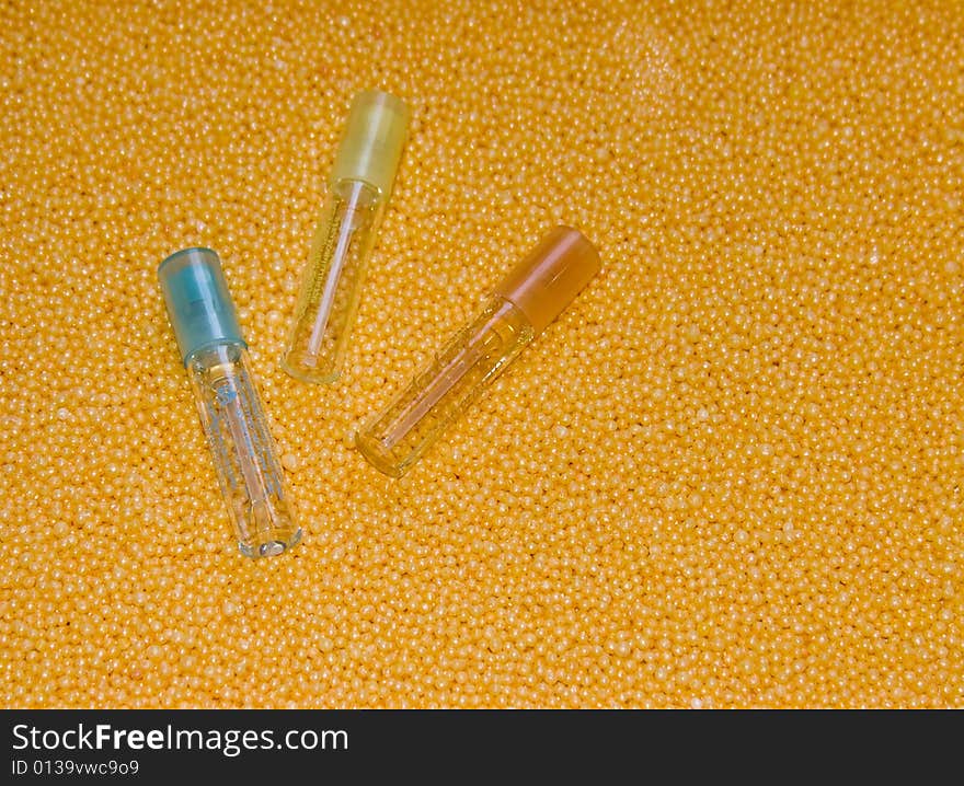 The image of three bottles lying on a yellow background