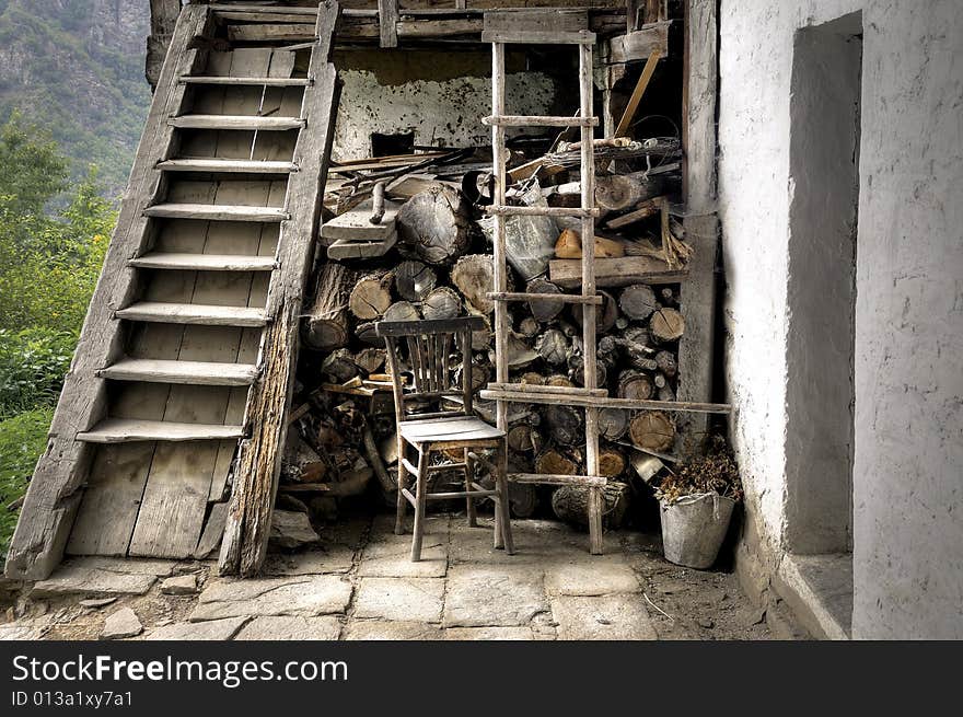 A chair beside stairs in front of an old bulgarian house. A chair beside stairs in front of an old bulgarian house