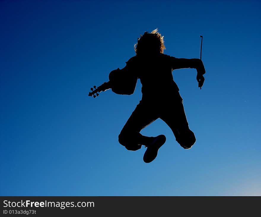 A person with a violin, jumping against the blue sky. A person with a violin, jumping against the blue sky.