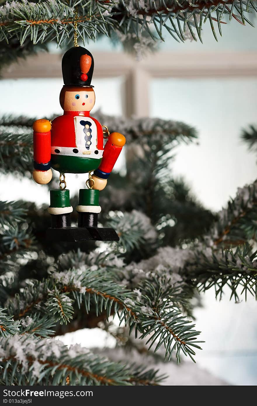 Christmas toy solider on tree near an old fashioned window