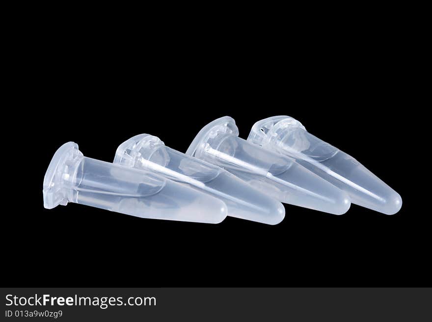 Empty eppendorf vials with white liquid isolated on black background