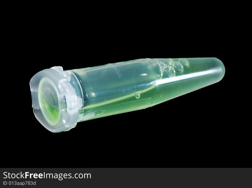 Eppendorf vial with green liquid isolated on black background