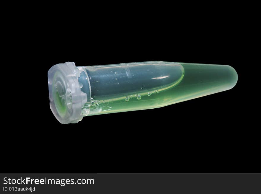 Eppendorf vial with green liquid isolated on black background