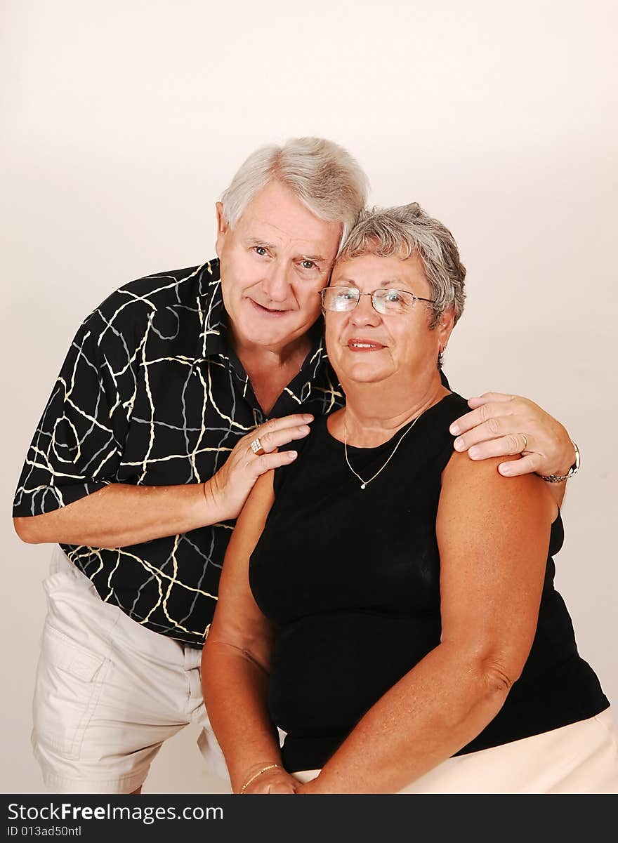 An happy senior couple looking in the camera. An happy senior couple looking in the camera.