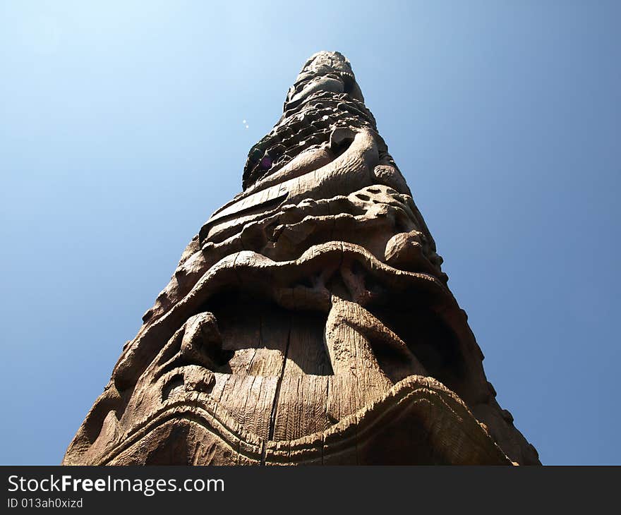 Looking up at a carved wooden Native American totem pole. Looking up at a carved wooden Native American totem pole.