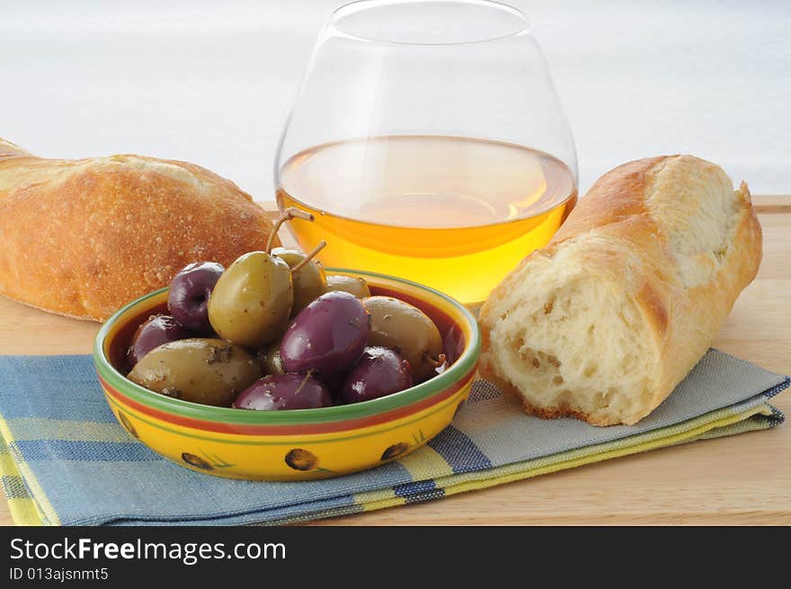 Dish of black and green olives with fresh bread. Dish of black and green olives with fresh bread.